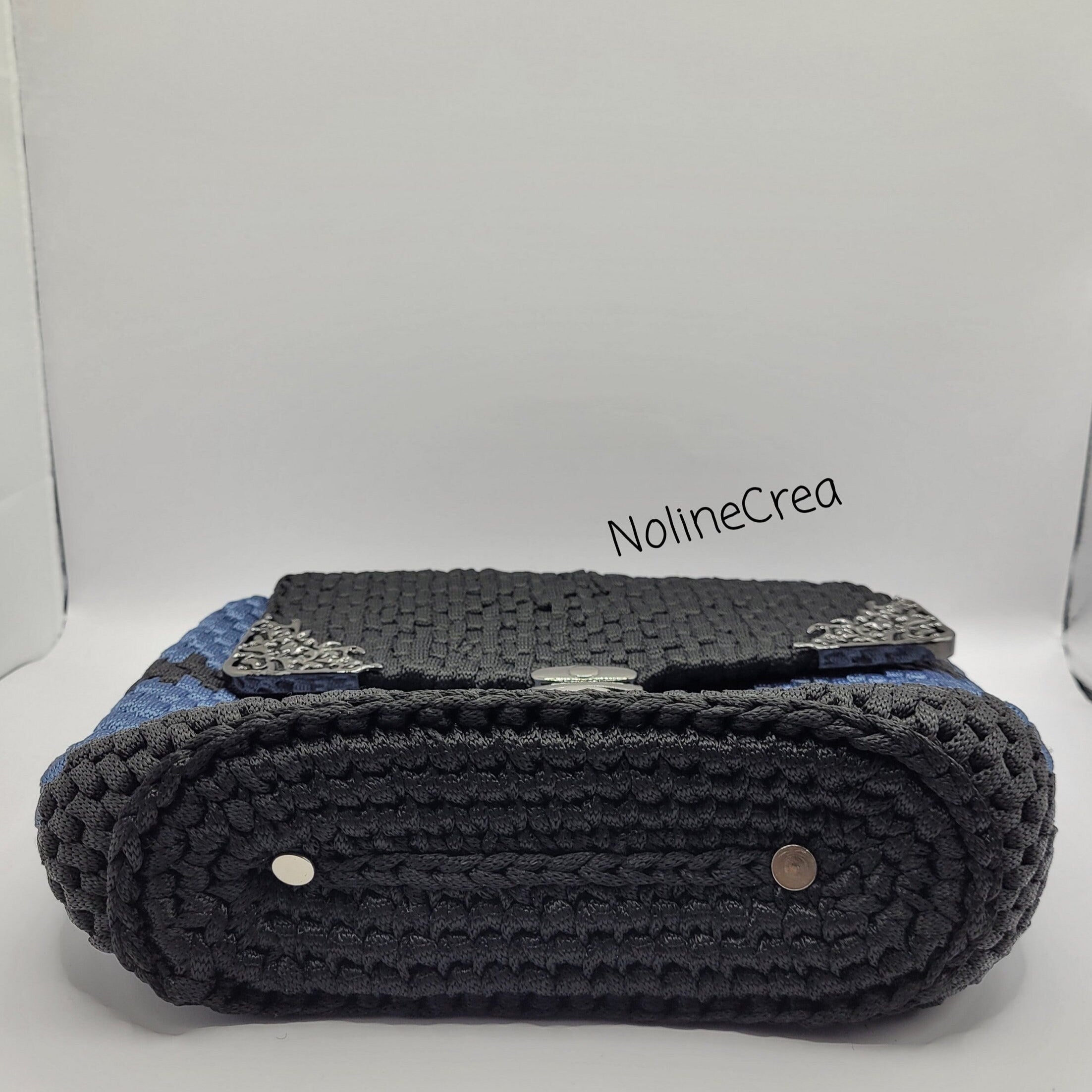 sac noir et gris au crochet avec fermeture et bijoux de coin
